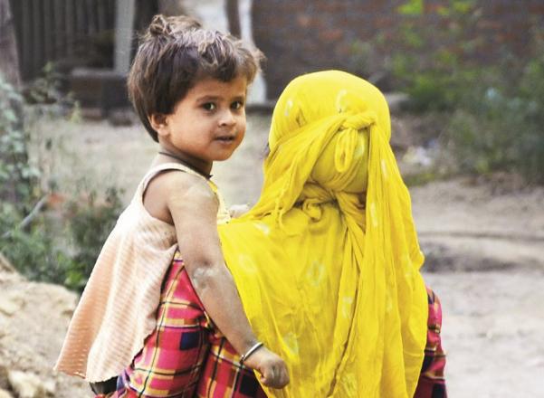 There is a building under construction where a working mother is working carrying her baby.Picture:PTI