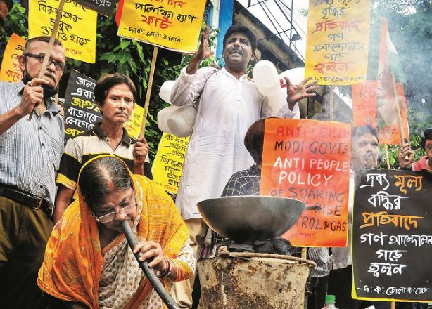 In West Bengal, Congress workers cook food on the street during a protest against rising fuel prices..Picture:PTI