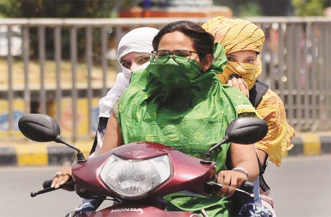 The girls are wrapped in blankets to avoid the heat in the state. (PTI)
