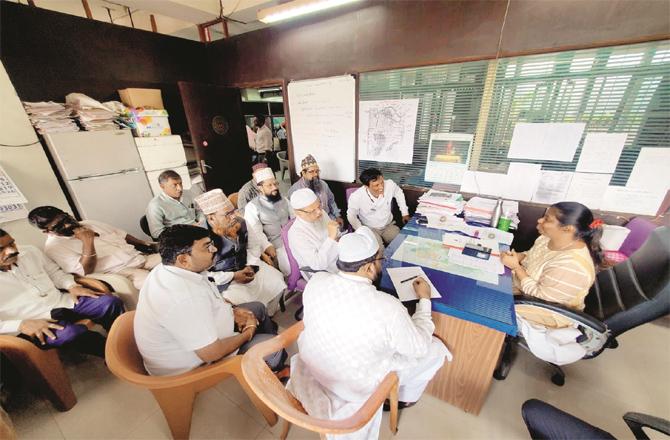 Scholars can be seen discussing measles with M Ward Health Officer Rupali Mitra