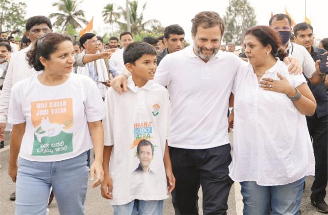 Rahul Gandhi with a woman and child during the `Bharat Jodo Yatra` in Karnataka