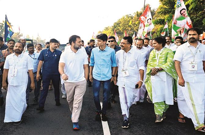 Rahul Gandhi talking to a youth during Bharat Jodu Yatra in Thrissur. (Photo: Agency)