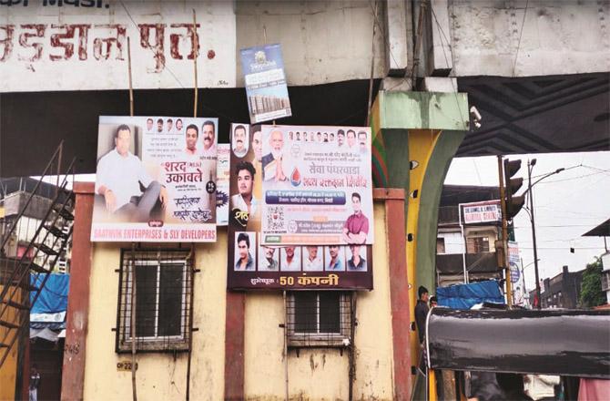 Illegal banners are visible under the flyover. Similarly, illegal posters are also pasted in the city.