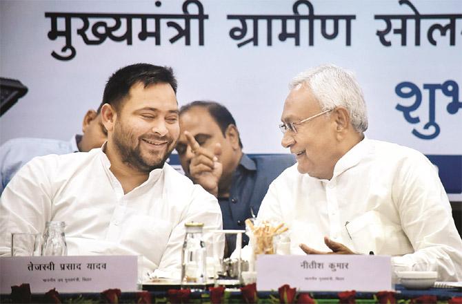 Bihar Chief Minister Nitish Kumar and Deputy Chief Minister Tejashwi Yadav in a happy mood on the occasion of the launch of `Rural Solar Light Project`.