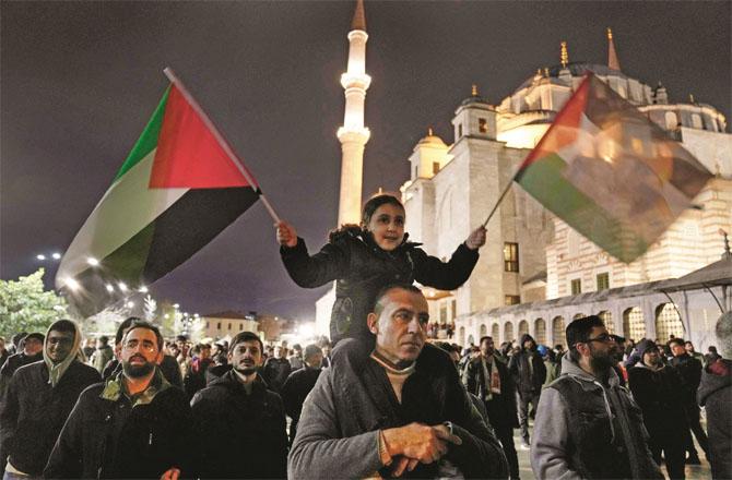 A child with a chum on a Palestinian during a protest against Israel. (AP/PTI)