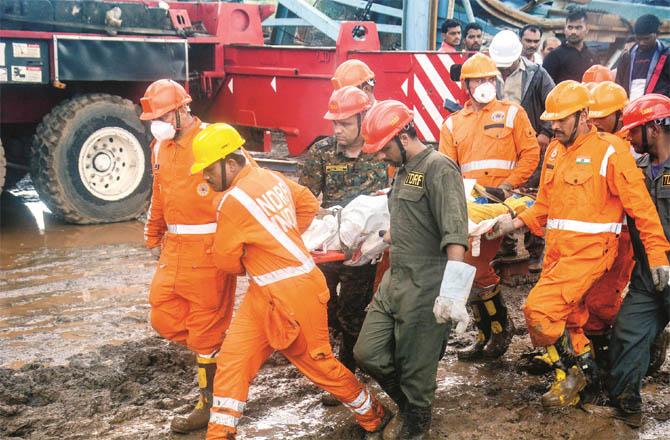Rescue team carrying a dead body