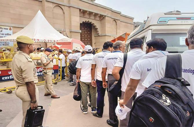 Officials of the Department of Archeology are standing in a queue to enter the Gyan Vapi Masjid. (PTI)