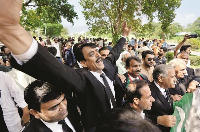 Lawyers and supporters of Imran Khan celebrate outside the Islamabad High Court. Photo. AP/PTI