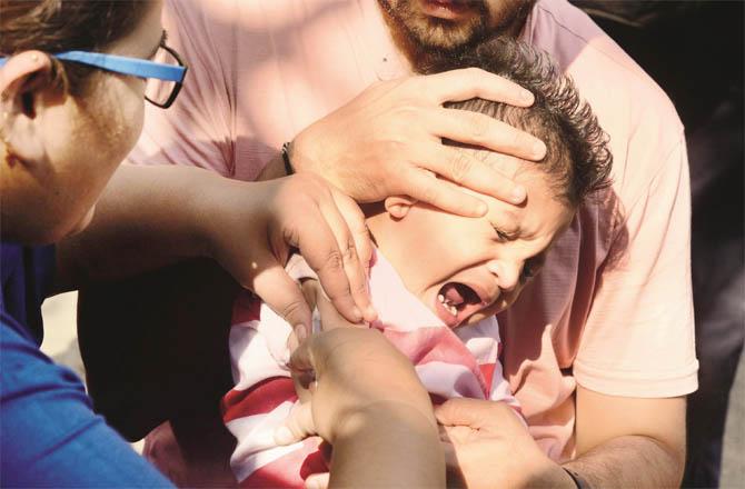 A child being vaccinated against measles.