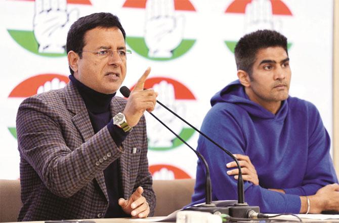 Vijender Singh and Surjewala can be seen at the press conference held at the Congress headquarters. Photo: PTI