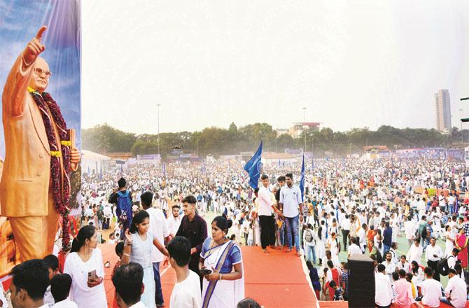 A crowd of people paying homage to Dr. Babasaheb Ambedkar is seen at Chetia Bhoomi
