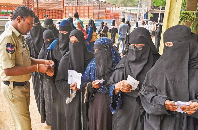 A large number of Muslim women are waiting to vote at a polling booth in Hyderabad. Photo: PTI