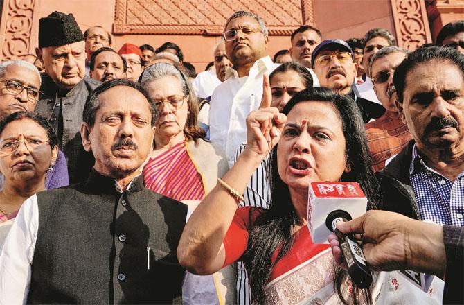 Mehwa Moitra protesting with opposition members in the Parliament premises. Photo: PTI