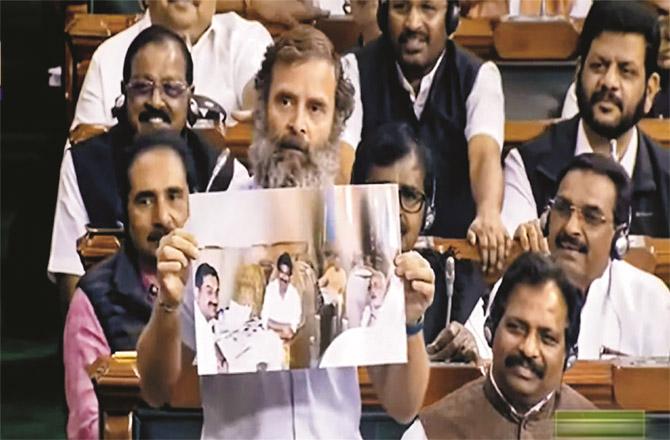 Rahul Gandhi showing the photo of Modi and Adani in the Lok Sabha. (PTI)