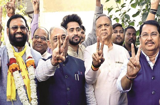 Congress workers show the victory sign after the victory of Sudhakar Udbale (left) in Nagpur.