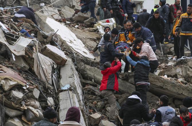 In Adana, Turkey, rescue teams are busy pulling out people buried under the rubble. Photo PTI