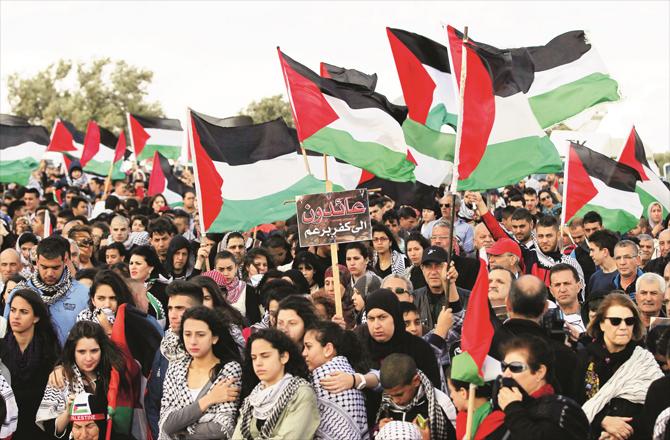 Palestinian citizens use their country`s flag in their protests.