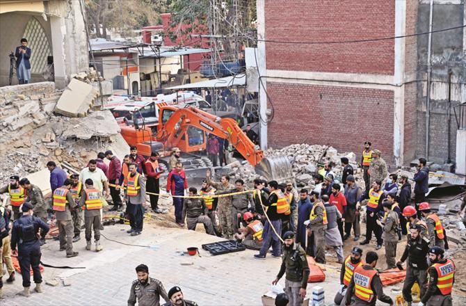 Security personnel and relief workers are busy removing the debris from the mosque. (Photos: AP/PTI)
