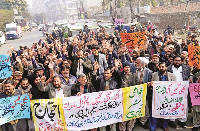 Rickshaw drivers protesting against the increase in prices of flour and other commodities in Lahore; (AP/PTI)