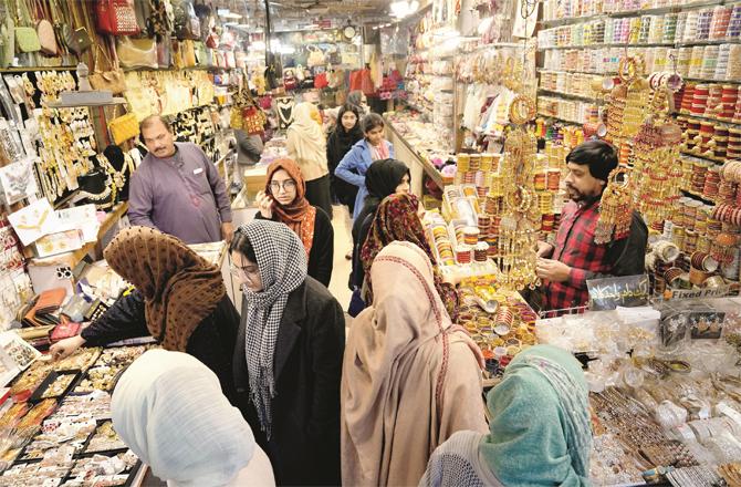 People are busy shopping in a bazaar in Lahore. (AP/PTI)