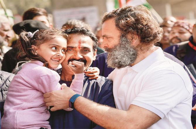 Rahul Gandhi talking to a girl during Bharat Jodu Yatra in Samba. (PTI)