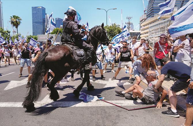 A scene of protesters blocking a highway in Israel being forcibly removed. (AP/PTI)