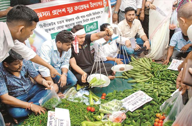 Congress workers in Assam during a protest against rising prices of vegetables. (PTI)