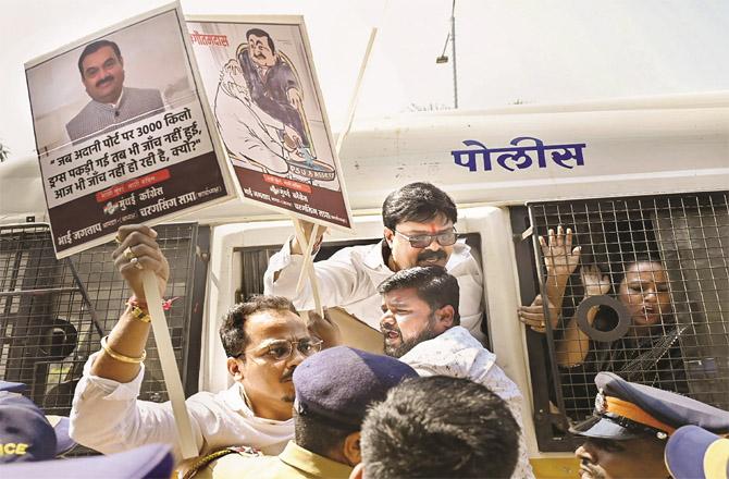 Congress leaders and workers protesting against Adani being taken away by the police. (Photo: PTI)