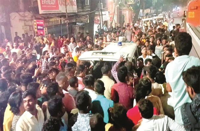 Local residents surrounded the police car after the accident