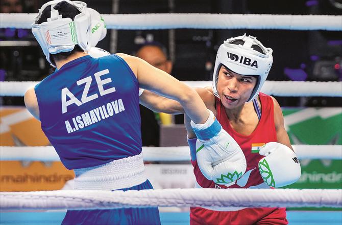 Indian boxer Nikhat Zareen (right) punches an opposing boxer. (PTI)