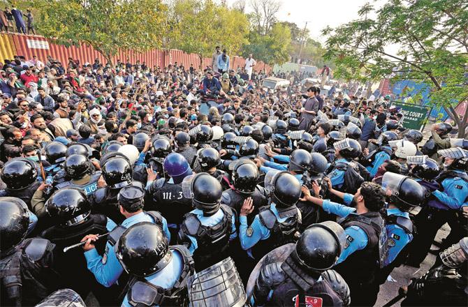 A scene of clashes between police and PTI activists outside the court premises in Islamabad.