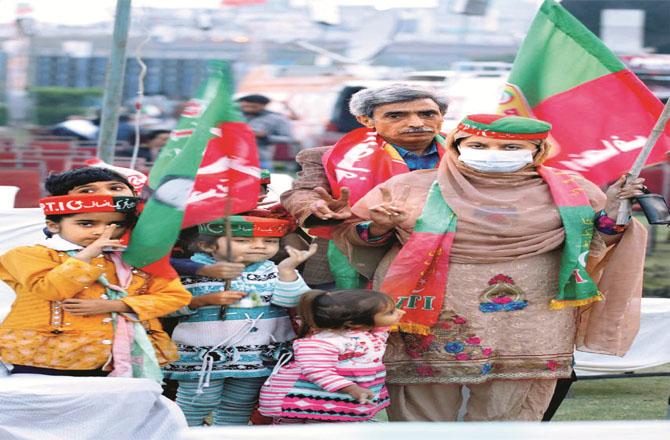 A family participating in the PTI rally.