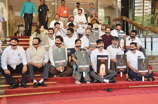 Opposition leaders protesting on the steps of the Assembly