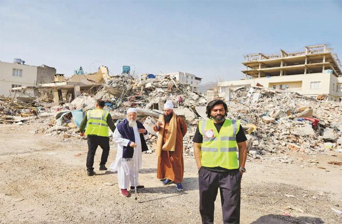 Moin Mian and Mohammad Saeed Noori in a devastated area of Turkey.