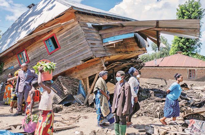 People look in front of a destroyed house in Congo`s South Kivu province. (AP/PTI)