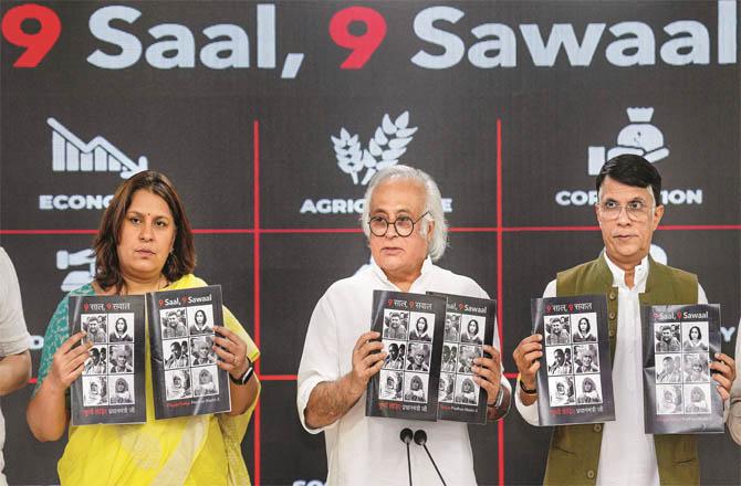 Pawan Khera, Jairam Ramesh and Supriya Shrineet releasing a booklet titled `9 Years, 9 Questions`. (PTI)