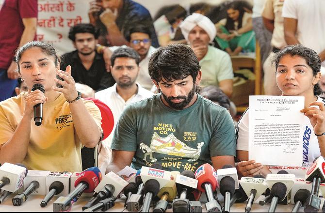 Wrestlers Sakshi Malik, Bajrang Punia and Vinesh Phogat addressing the press conference (PTI)