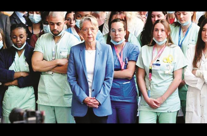In a hospital in France, medical staff are seen observing a minute of silence.
