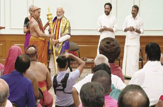 Prime Minister Narendra Modi accepting `Sengol` from Adhinam from South India on Saturday.