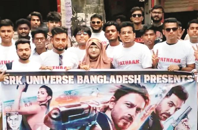 People of Bangladesh with the poster of the movie Pathaan