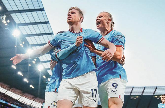 Manchester City players celebrate after scoring against Real Madrid.