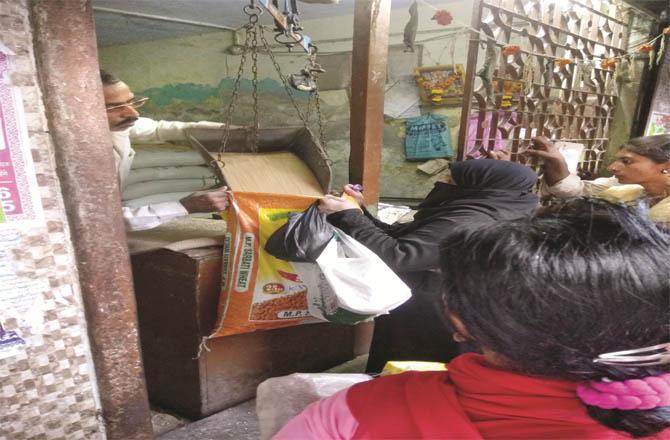 A woman buying grain from a ration shop. (file photo)