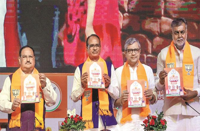 JP Nadda, Shivraj Singh Chouhan and Ashwini Vishnu releasing the election manifesto. Photo: PTI