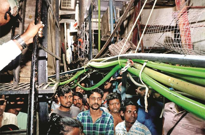 People can be seen outside the house in Fittergally. Photo: Anurag Ahire