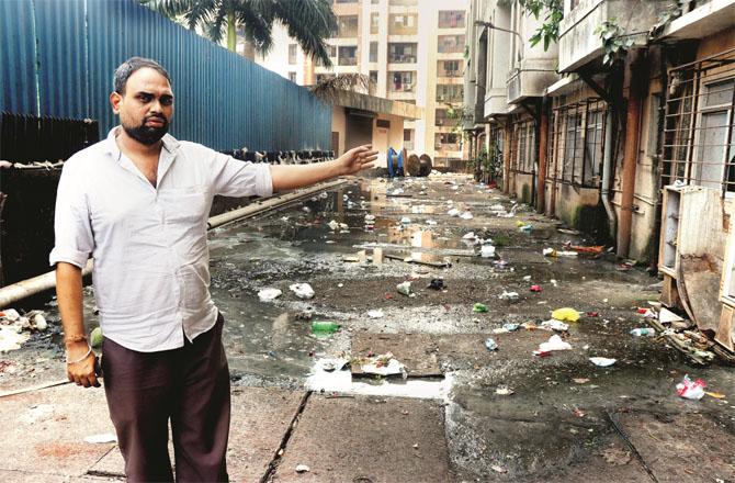Mahesh Mishra, a resident of a rental colony in Khewra Circle, pointing at the dirt.
