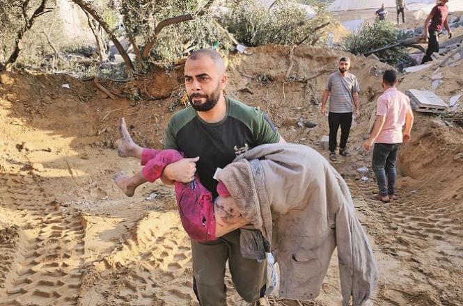 A person taking an injured child to the hospital. Photo: AP/PTI