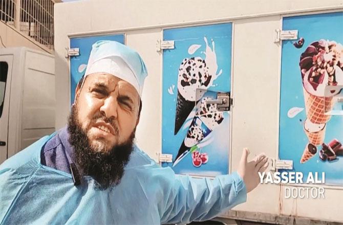 Dr. Yasir Ali of Al-Shifa hospital in Gaza shows the ice truck that holds the bodies. Photo: INN