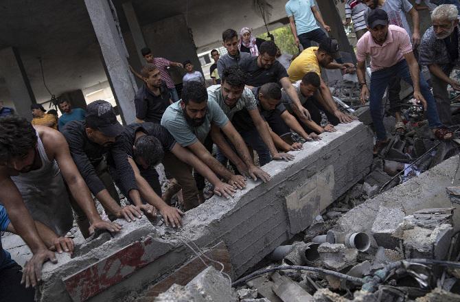Palestinian finding people under debris. Photo: PTI