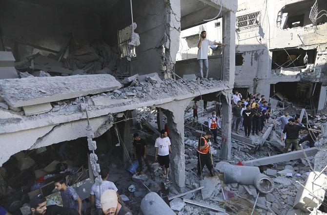 Searching for people trapped in Palestinian rubble. Photo: PTI