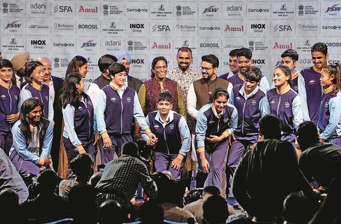 Anurag Thakur and P. T. Usha can be seen with the players at the unveiling of the kit and attire. Photo: PTI